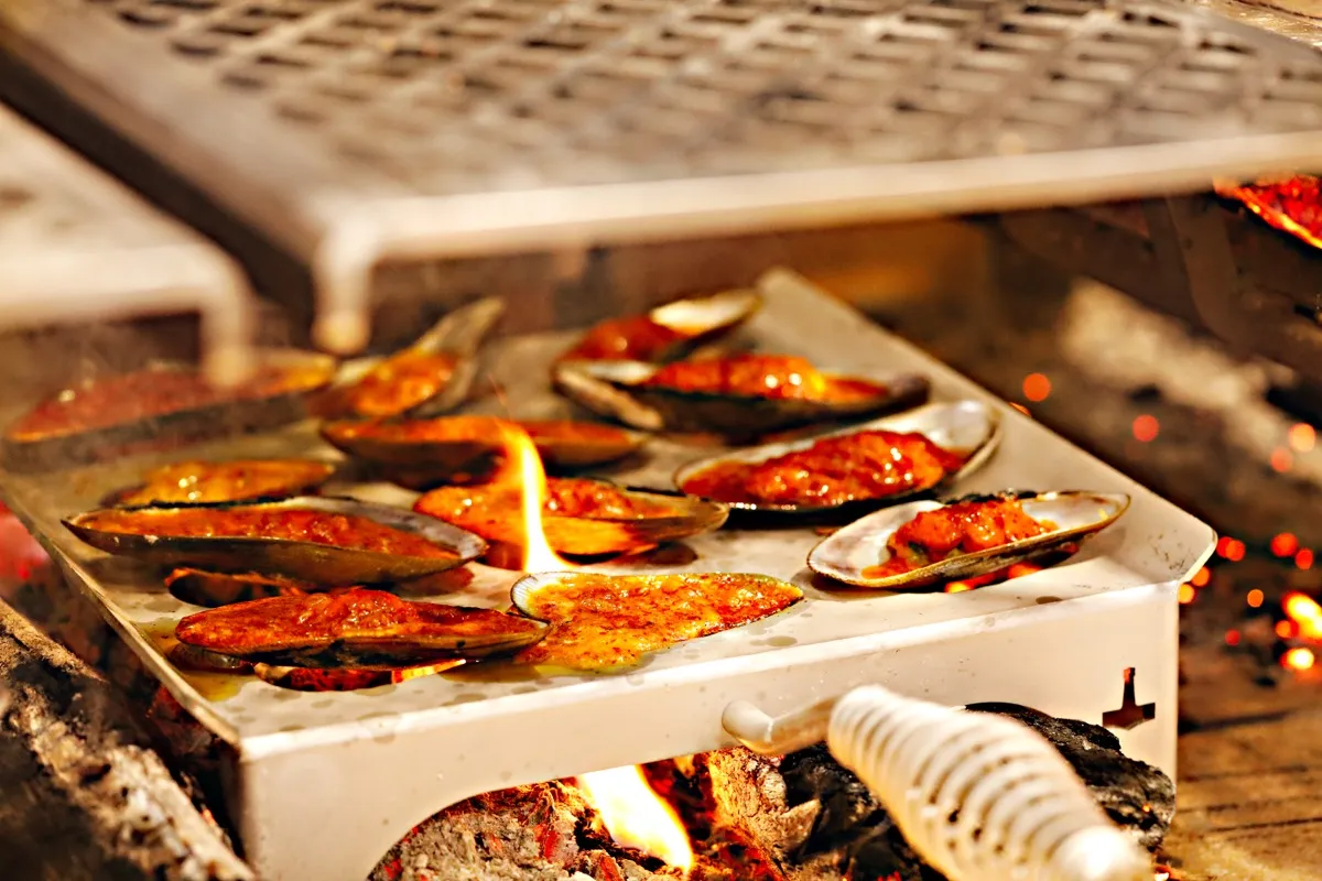 Mussels roasting over the wood-fired hearth